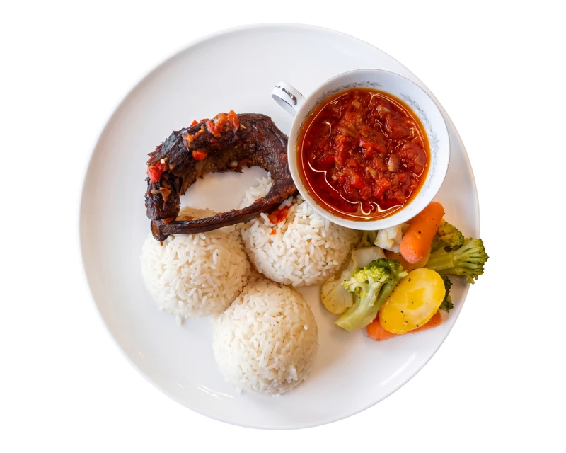 Coconut rice with two proteins at D'lara Kitchen, Nigerian restaurant in Winnipeg